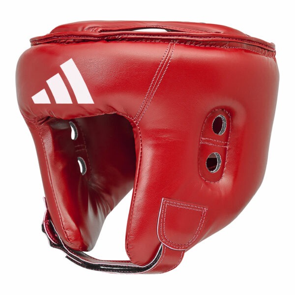 Opposite front angled view of the Adidas boxing head guard in red showing padded cheek protection, ventilation eyelets, and Adidas logo.