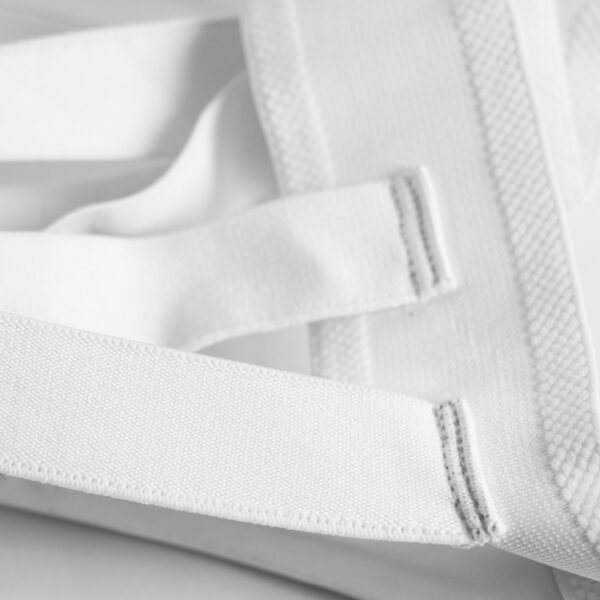 Close-up of the Adidas WKF Approved ladies karate groin guard showing the elastic support straps and reinforced waistband.