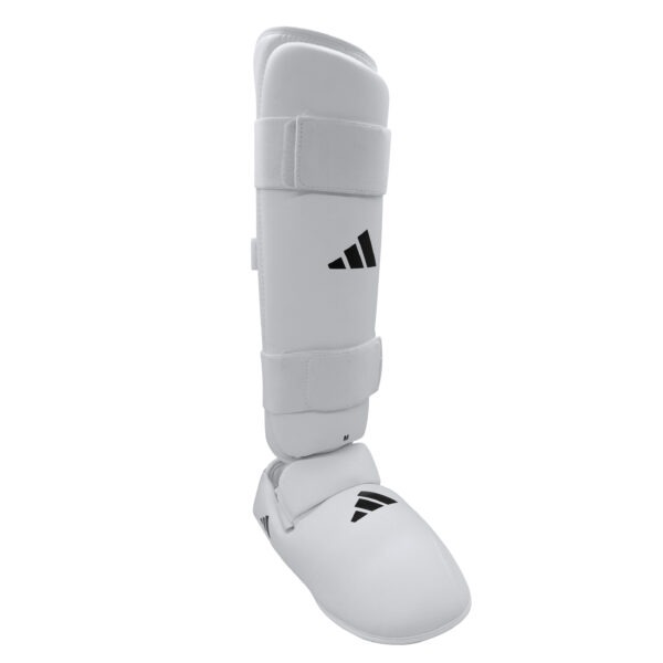 Adidas white removable karate shin and instep guard with adjustable hook-and-loop straps for karate training and competition.