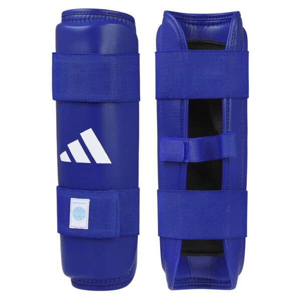 Front and inner view of the Adidas WAKO shin guards in blue with hook-and-loop straps, cushioned lining, and WAKO approved label.