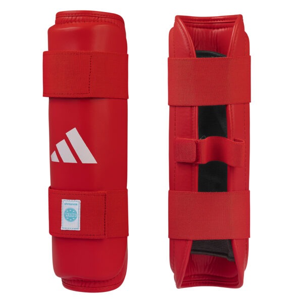 Front and inner view of the Adidas WAKO shin guards in red with hook-and-loop straps, cushioned lining, and WAKO approved label.