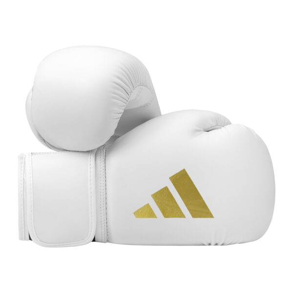 Pair of Adidas Speed 50 boxing gloves in white with gold Adidas logo featuring hook-and-loop wrist closure and multi-layer foam padding.